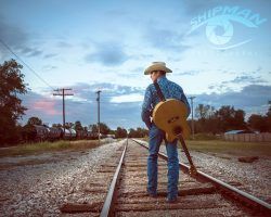 Senior portrait of a boy on train tracks near Tulsa Ok