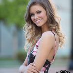 smiling high school senior girl in a natural light portrait