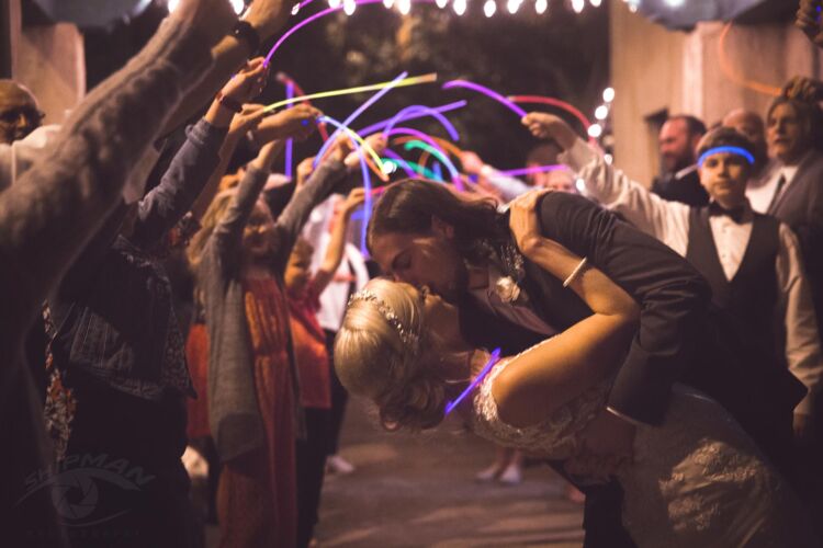 Wedding candid of groom kissing bride