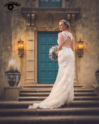 beautiful bride on the steps of Dresser mansion in Tulsa, on her wedding day