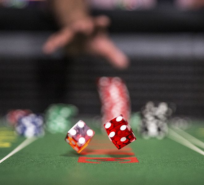 Throwing dice at gaming table