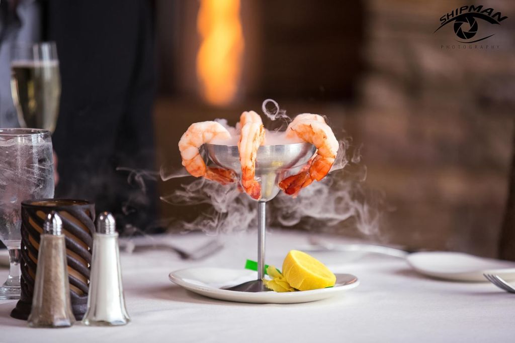 Shrimp dish with dry ice smoke wafting around it food and beverage photography