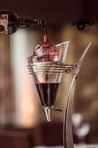 red wine being poured over a crystal decanter in a fine dining restaurant in Tulsa