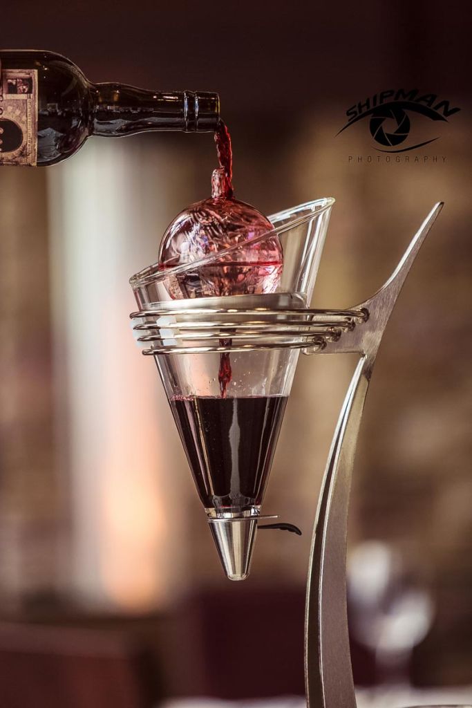red wine being poured over a crystal decanter in a fine dining restaurant in Tulsa