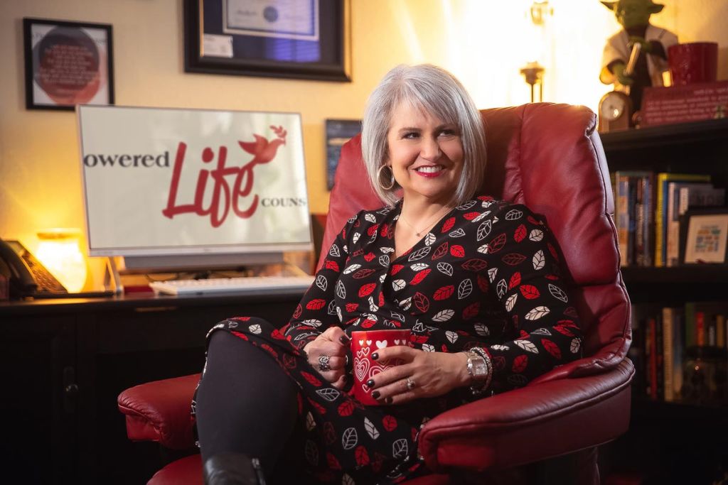 counselor sitting in office chair with big smile, holding cup of coffee professional advertising professional photography Tulsa