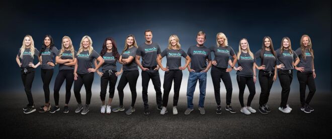 team composite photo of orthodontist office staff standing on a concrete floor that fades off into a blue background