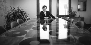 young man sitting at the end of a table full of records at The Church recording studio