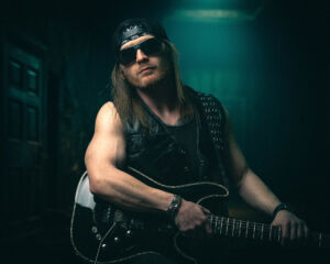 Rock musician with guitar in moody stage lighting