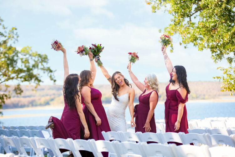 Bride and bridesmaids celebrating the wedding by the lake