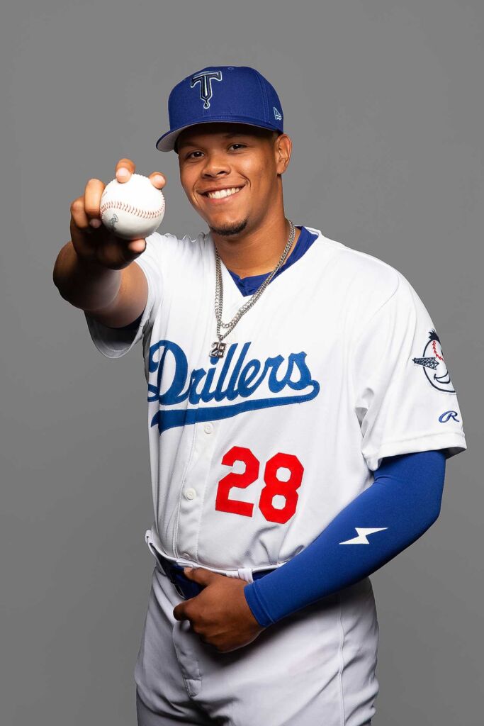 Tulsa Driller baseball player smiling and showing you a baseball