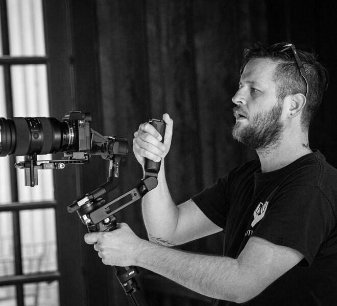 Videographer using hand held gimbal and camera to shoot a wedding production in Tulsa