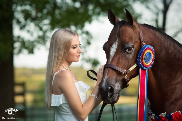 Beautiful young woman with her prize winning horse
