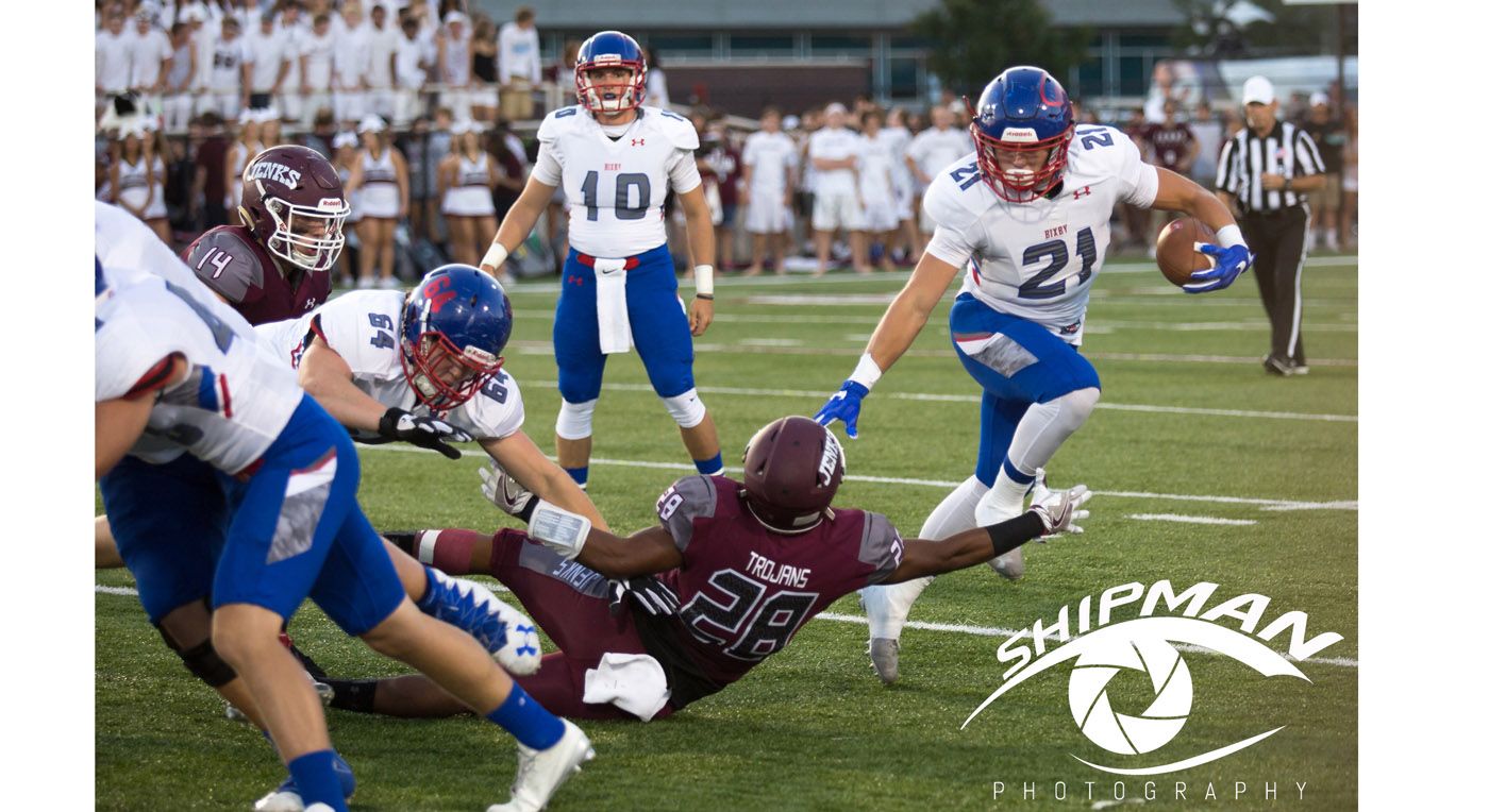 DC5A1494 football action shot, running back stiff arming defender - live action sports event photography