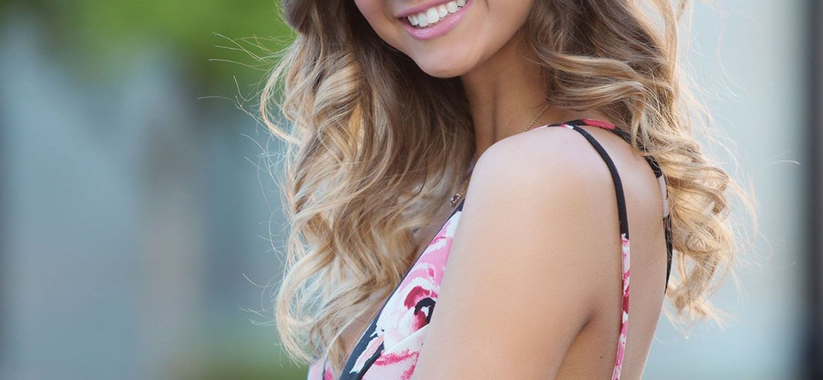 smiling high school senior girl in a natural light portrait