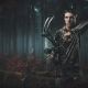 young man in the deer woods at night with a bow and arrow