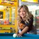 Smiling young woman playing pool