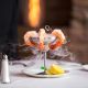 Shrimp dish with dry ice smoke wafting around it food and beverage photography