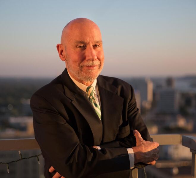 Tulsa attorney on a downtown rooftop in a suit