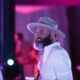 Bearded man in a hat enjoying himself and dancing at a party. Candid event photography in Tulsa
