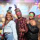 Friends posting on branded background at hard rock posed event photography in Tulsa
