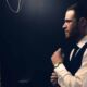 Groom getting ready in the mirror for his wedding day - cinematic video production in Tulsa