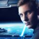 young jedi stands on deck of star destroyer with a lightsaber in his hands